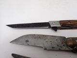 two knives that are laying next to each other on a table