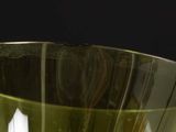 a close up of a green vase with a blurry background