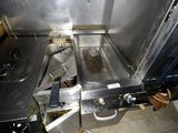 an image of a kitchen with a sink and a stove