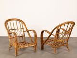 pair of rattan lounge chairs in the style of the early 20th century