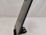 the tablet is sitting on a stand on a white surface