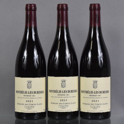 three bottles of wine are lined up on a table