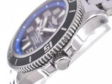 a close up of a watch with a blue face