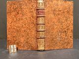 an old book sitting on top of a table next to a pair of scissors