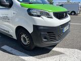 a white and green van parked in a parking lot