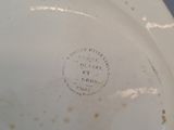 underside view of a white porcelain toilet bowl with the lid down