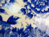 a large blue and white plate with flowers on it