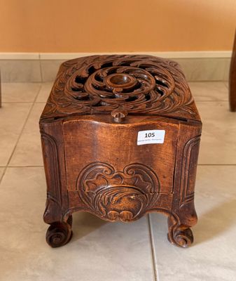 a small wooden box on the floor with a price tag on it