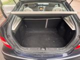 the back of a car with its trunk open and the seat folded down