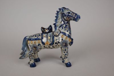 a blue and white horse figurine on a white background