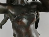 bronze statue of a woman holding a flower in her hand