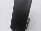 a cell phone that is sitting on top of a stand