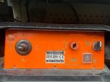 an orange box with buttons on it sitting on a table
