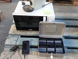 a microwave sitting on top of a pallet with a laptop on it