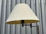 a lamp that is on a metal pole in front of a building