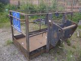 a metal cage with a sign on it sitting in the grass