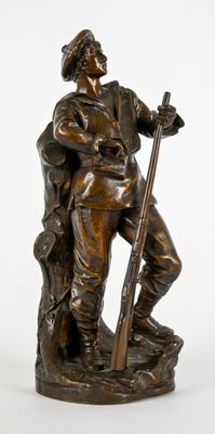 statue en bronze représentant un homme avec un fusil et un chien