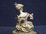 a statue of a woman sitting on top of a table