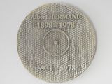 a silver coin with a picture of a man on it