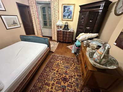 a bedroom with a bed and a dresser in it