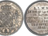 a close up of a coin with a coat of arms on it