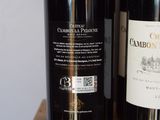 two bottles of wine sitting on a table next to each other