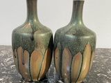 two vases that are sitting on a table