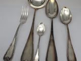 five silver spoons and two silver spoons on the table