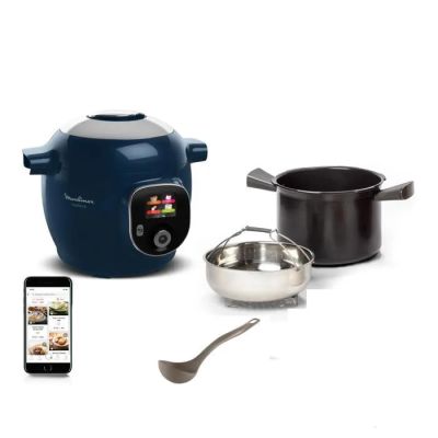 a blue and white rice cooker with a spoon and a cell phone next to it