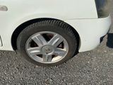 a close up of a car ' s tire on the road