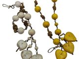 yellow and white beaded necklace and earring set on a white background