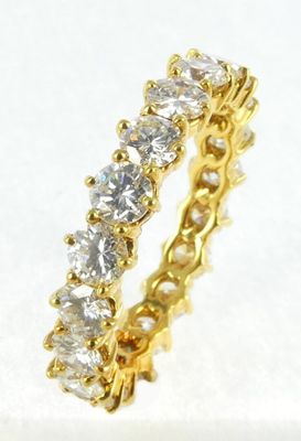 a close up of a diamond ring on a white surface
