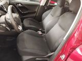 the interior of a red car with black seats and a steering wheel