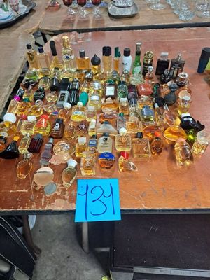 many bottles of alcohol sitting on a table with a price tag