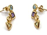 two pairs of gold earrings with multi colored stones on them