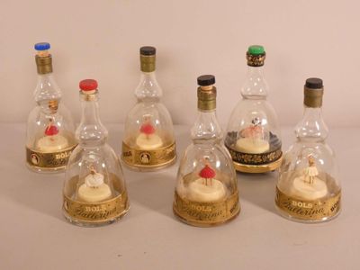 sept bouteilles d'alcool contenant chacune un cupcake
