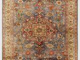 a blue and red rug with a floral design on it