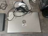 a laptop and a mouse on a table with other electronics