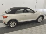 the rear end of a white volkswagen suv with a black top