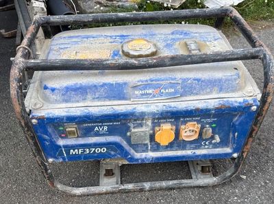 a small blue generator sitting on the ground next to a motor scooter