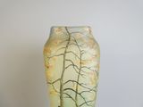 a glass vase with a painting of a tree on it
