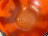 an orange bowl that is sitting on a table