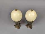 pair of white glass lamps with gold accents on a gray background