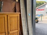 a garage door that has been smashed open and is leaning against the side of a building
