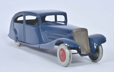 a toy model of a blue car on a white surface