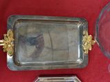 a silver tray with a picture on it next to a glass bowl