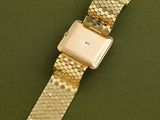 an image of a watch sitting on top of a green surface
