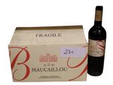 a bottle of wine sitting next to a box of wine