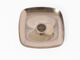 a silver plate with a coin in it on a white surface