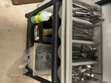 a small refrigerator with a lot of utensils inside of it
